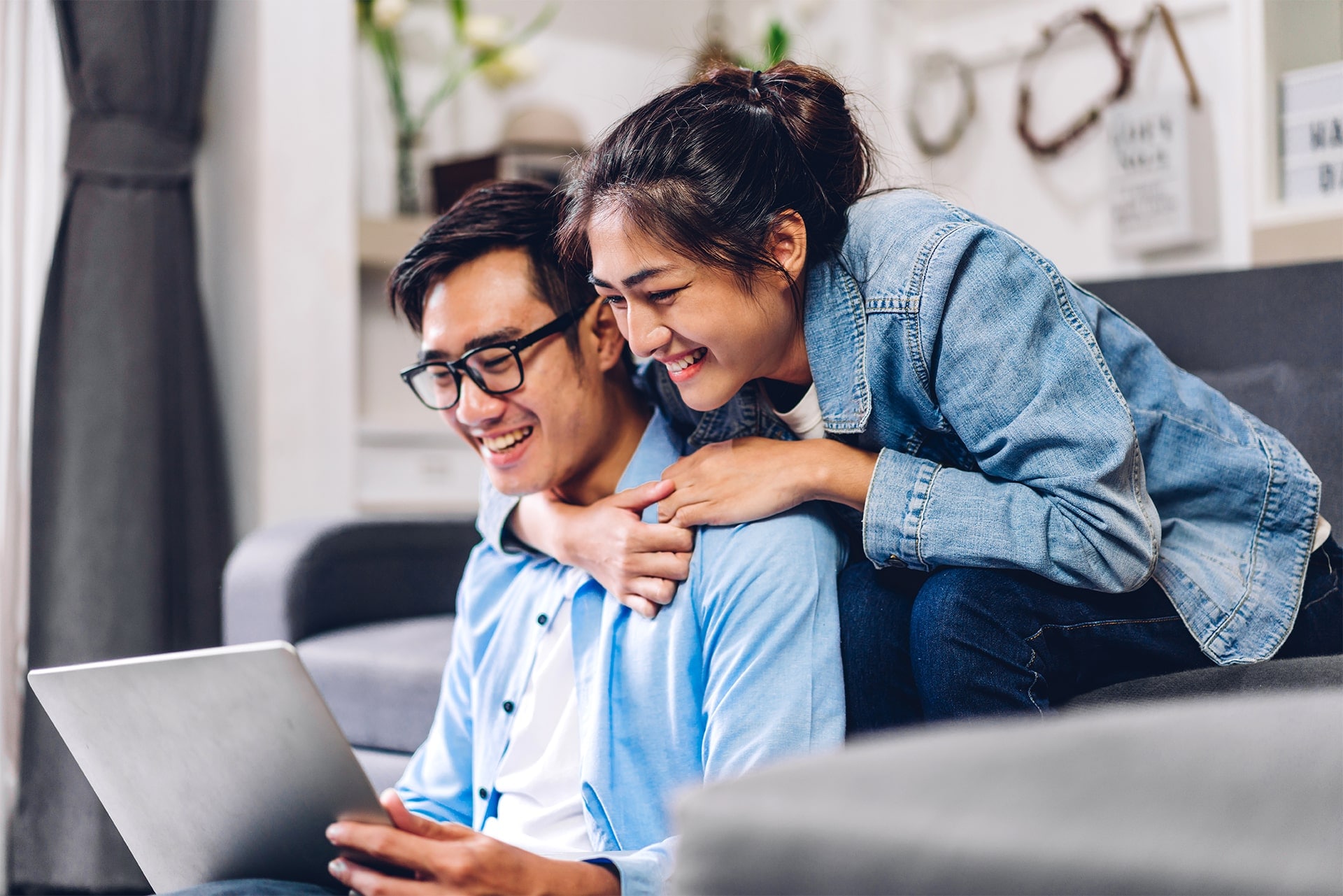Young asian couple relaxing using laptop computer working and video conference meeting online chat.Creative business couple planning and brainstorm at home